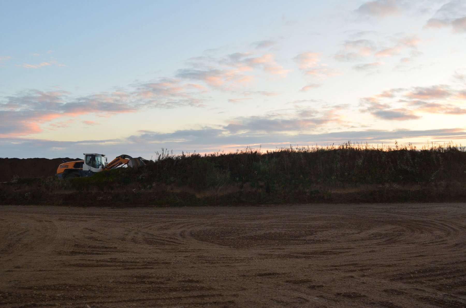 Topsoil removal with excavator on an archaeological site
